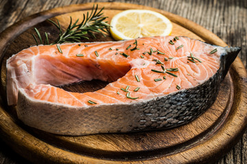 fresh raw salmon on wooden cutting board
