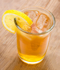 Summer drink with lemon on wooden base