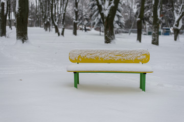 single bench covered with snow