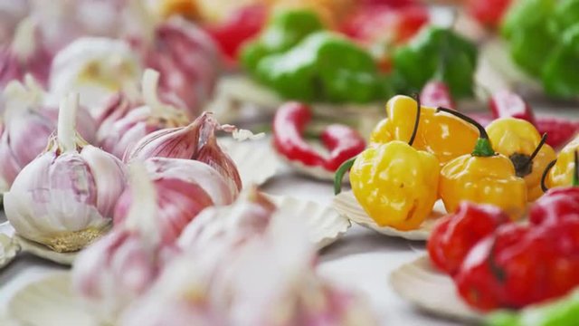 Close-up shot hand choosing bulbs of garlic and different peppers in Rio de Janeiro, Brazil