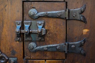 Medieval door lock. Oak door with iron lock.