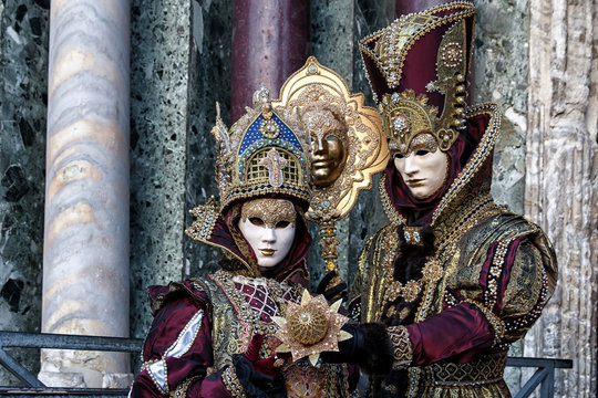 Masks in beautiful multicolored costumes at Carnival in Venice, Italy