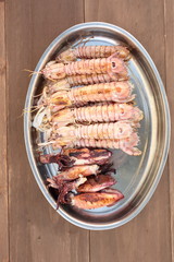 tray of seafood cooked on the grill
