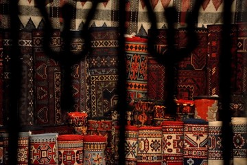 View into a carpet shop through wrought iron window in Baku's Old City. A scene from a UNESCO world heritage site in Baku, the capital of Azerbaijan
