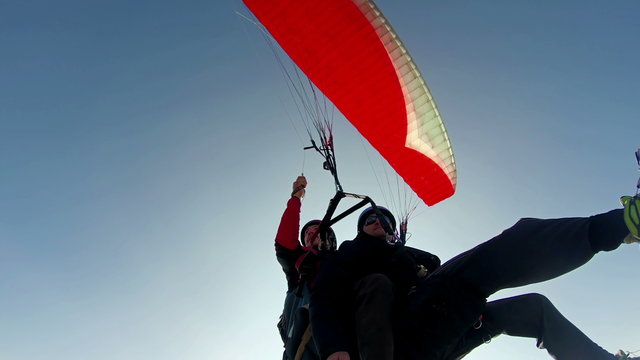 Tandem paragliding flight view from bellow 