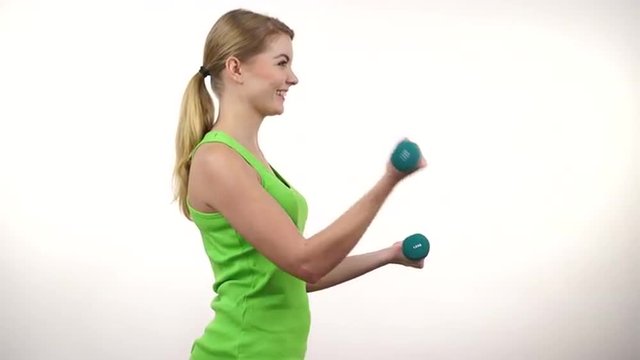 Woman exercising with dumbbells lifting weights 4K