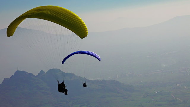 Paragliders fly over amazing mountain range 