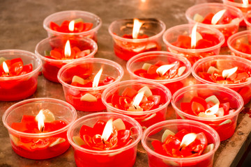 Burning red flower candle at chinese shrine for making merit in chinese new year festival. Pray for...