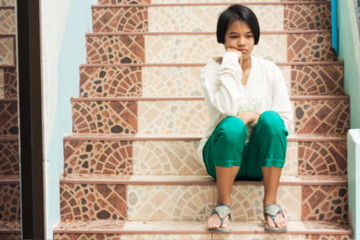 blurry,girl sad sitting alone at staircase in the park