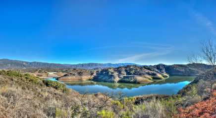 Panoramic view of California lake's western shore of Casitas and low water line.