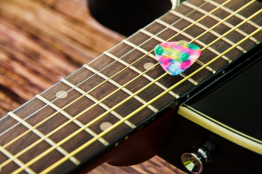 Acoustic guitar black color and plastic pick