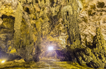 Fototapeta na wymiar Beauty spectacular limestone caves Nguom Ngao with natural tectonic strange shapes, surprise, giant help of light makes cave more mysterious shimmering, here is the national scenic spots Vietnam