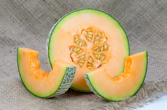 Melons, cantaloupe slices isolated on white background