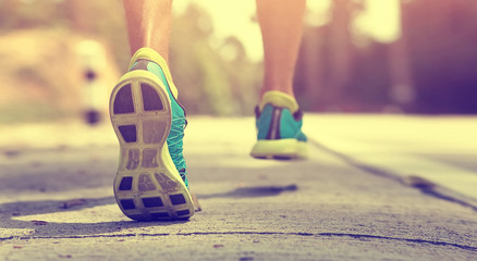 Athlete runner feet running on treadmill closeup on shoe