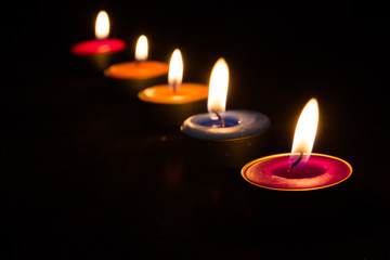 Burning candles on a dark background with warm light