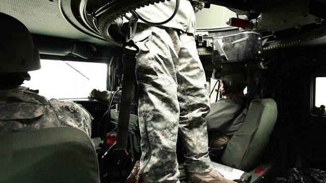 Shot of soldiers in a Humvee including the turret gunner.