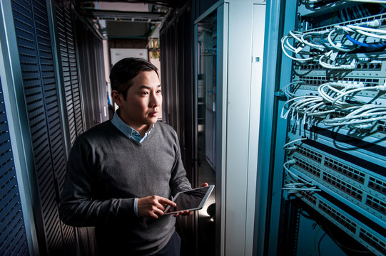 Young engineer businessman in server room