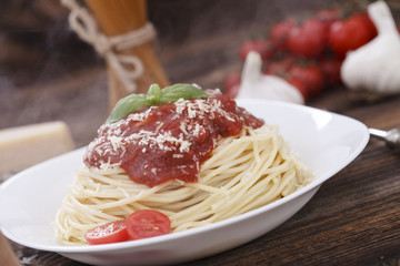 Warm, delicious spaghetti with sauce and basil.