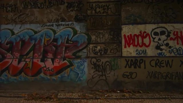 Slow tracking of tunnel wall showing tags and graffiti