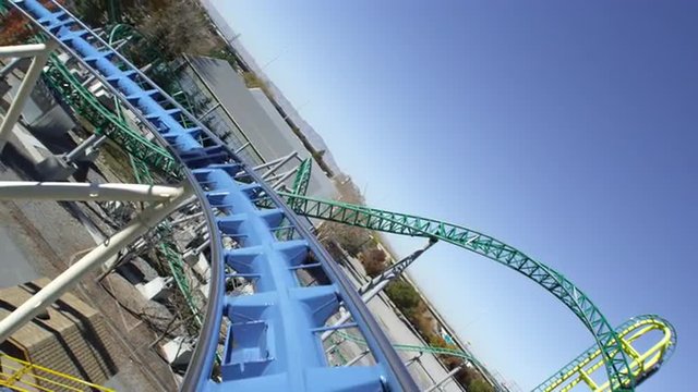 First person view of a roller coaster riding the peaks and slopes of the track.