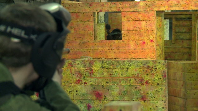 The game of paintball.A player shoots in the head.