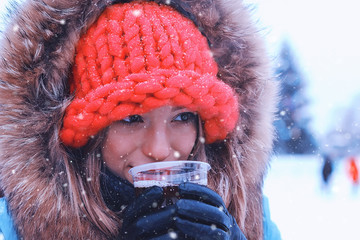 portrait of a young girl in the winter drink wine