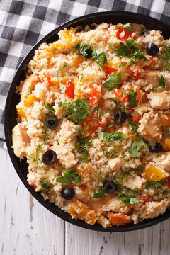 couscous with meat and vegetables close-up. vertical top view
