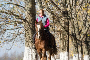 Young girl riding horses