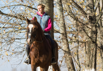 Young girl riding horses