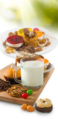 image of cup of milk and many cookies close-up