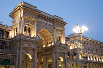 Fototapeta na wymiar Entrance to the Vittorio Emanuele II Shopping Gallery in Milan, Italy, illuminated at night