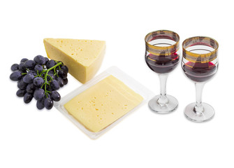 Red wine, grapes and cheese on a light background