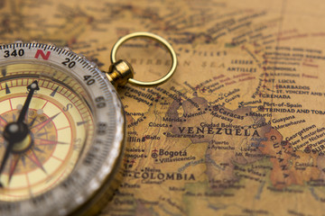 Fototapeta na wymiar Old compass on vintage map selective focus on Venezuela
