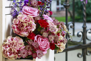 Floral arrangement with pink roses, carnations and delphinium fl