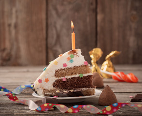 Piece of Birthday Cake on wooden background