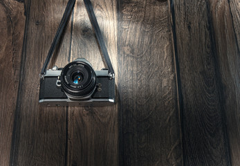 Old photo camera hanging wooden boards. Copyspace - space for text