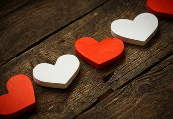 Red and white hearts on old wooden background