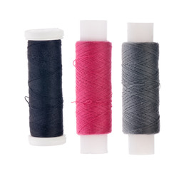three spools of thread isolated on white