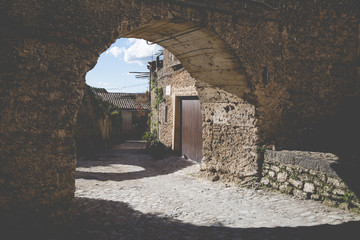 View of a Medieval Arch in a Little Village. Vintage Filter Applied.