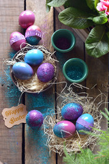 Easter egg painted with bright colors and glitter.