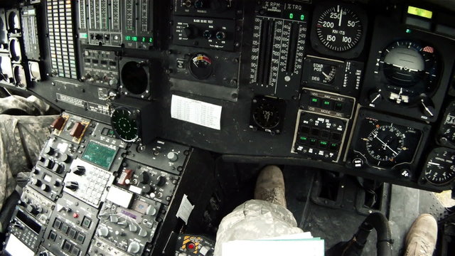 Black Hawk copilot looking at and adjusting instruments.