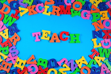 Teach written by plastic colorful letters