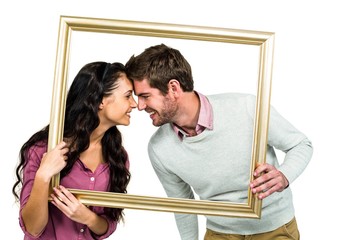 Happy couple holding picture frame