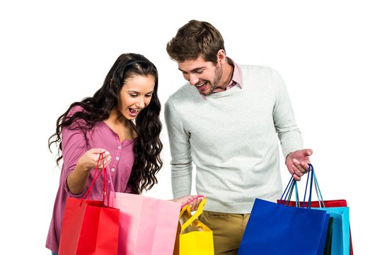 Excited couple with shopping bags