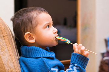 little boy eats candy