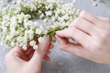 Florist at work. How to make gypsophila paniculata wedding wreat