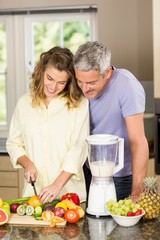 Smiling couple preparing healthy smoothie