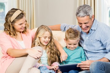 Happy family using tablet on the sofa