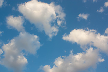 Blue sky background with white clouds.