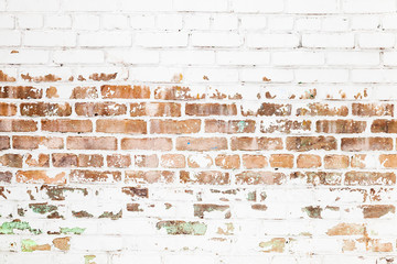 Old red brick wall with damaged white paint layer